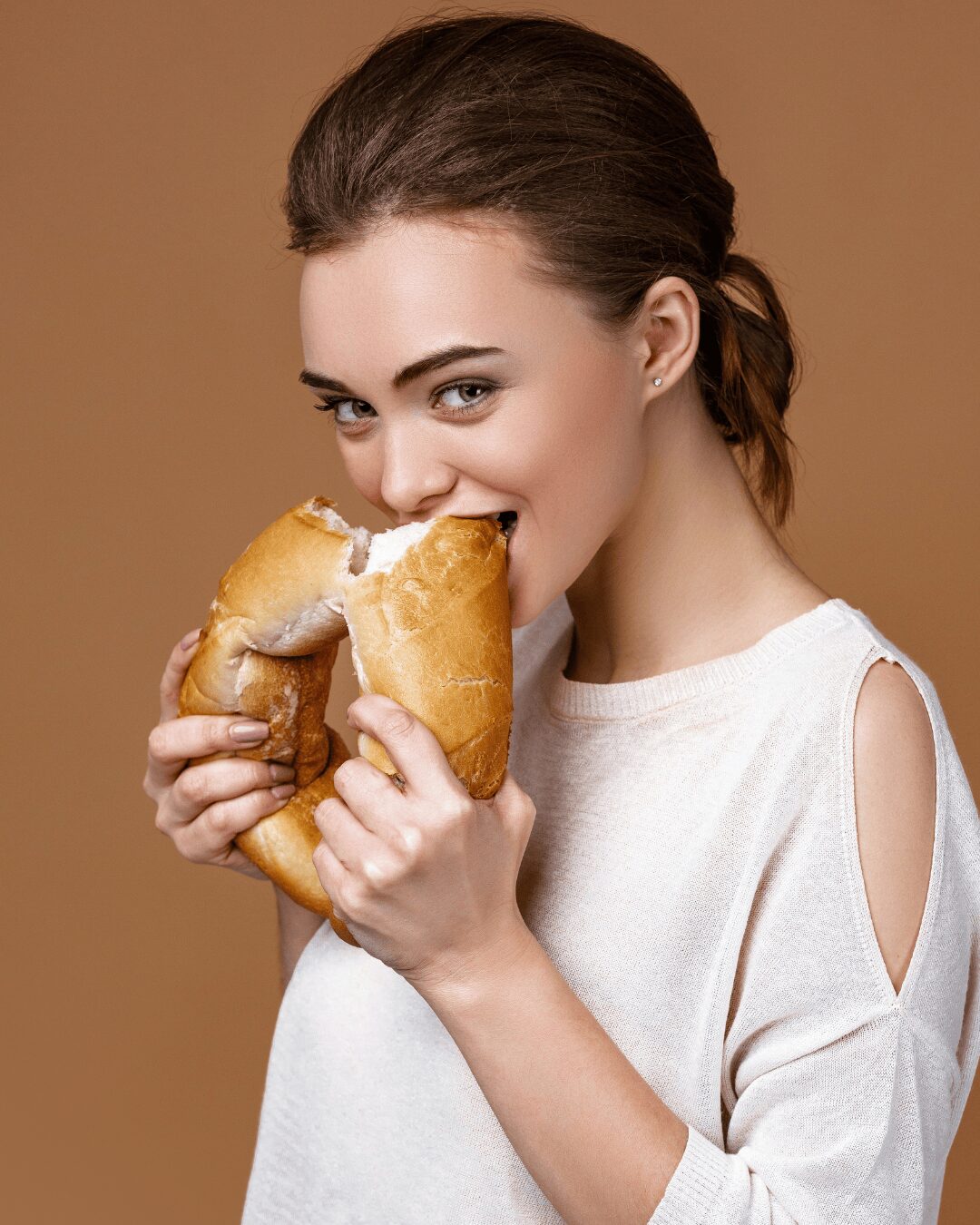 Chica comiendo pan.