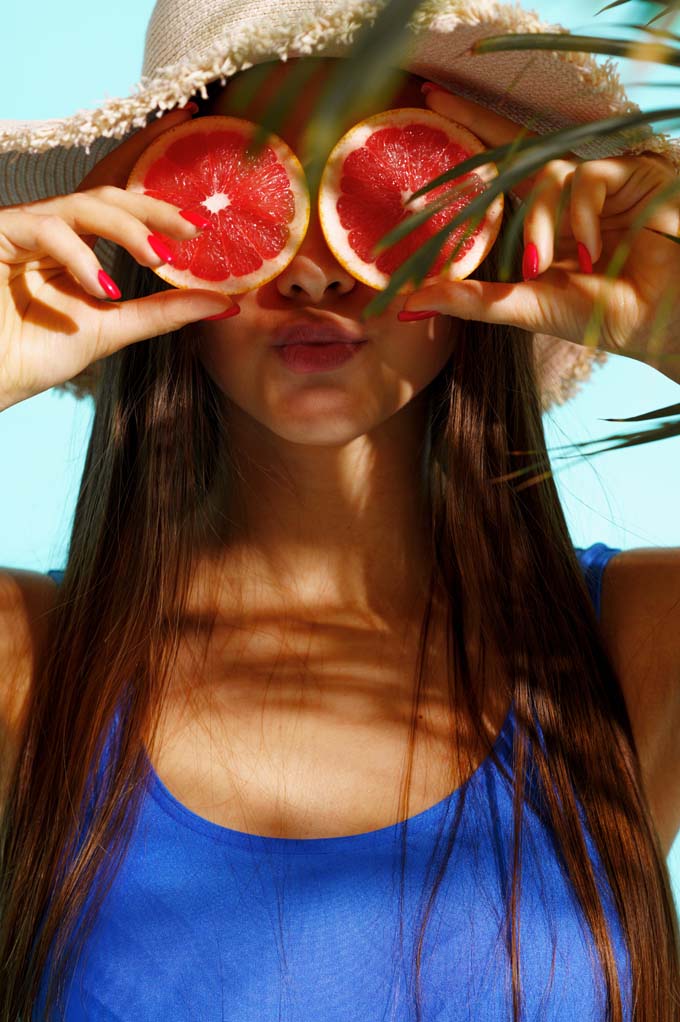 Chica con naranjas en la cara